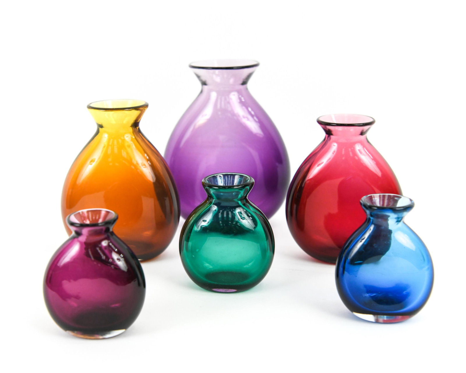 (6) 20TH C. STUDIO GLASS FLASK BOTTLE VASES: (6) studio/art glass bottles, all signed indistinctly and dated underneath from 1991-1998. Various colors. Flask bottle form vases. Dimensions: (Largest) H 7.5" x W 5.75" x D 2.75" Condition: Few ligh