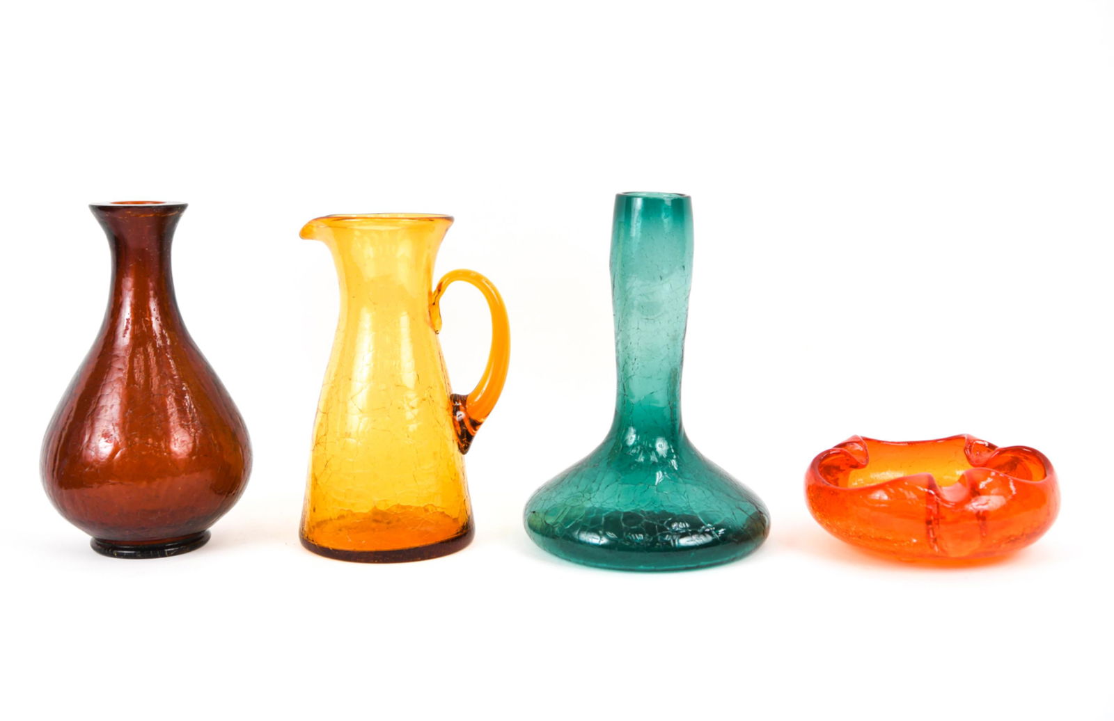 (4) PIECES MID-CENTURY CRACKLE GLASS INCL. BLENKO: Including: Blenko C-5712 Genie "Bottle Vase" in Sea Green/Juniper, c. 1958; beaker-style pitcher with applied handle in honey glass, likely Blenko No. 977 c. 1954; Tangerine glass 7.5" ashtray; heavy