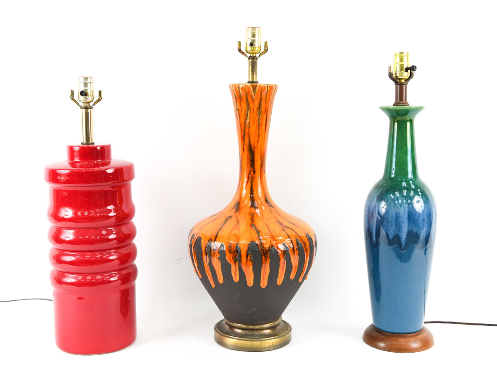 (3) MID-CENTURY CERAMIC TABLE LAMPS: Including: attr. Royal Haeger atomic orange lava drip glaze lamp; blue and green drip glaze lamp; and mid-century Scandinavian hooped red-glazed ceramic table lamp. Dimensions: (Tallest) H 28" x Dia. 