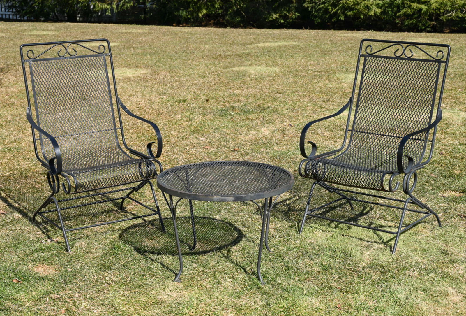 IRON OUTDOOR CHAIRS AND TABLE: Beautifully crafted wrought iron outdoor set. Dimensions: (Chair) H 38" x W 22.25" x D 24.25" Condition: Wear consistent with outdoor use including losses to finish and slight patina.
