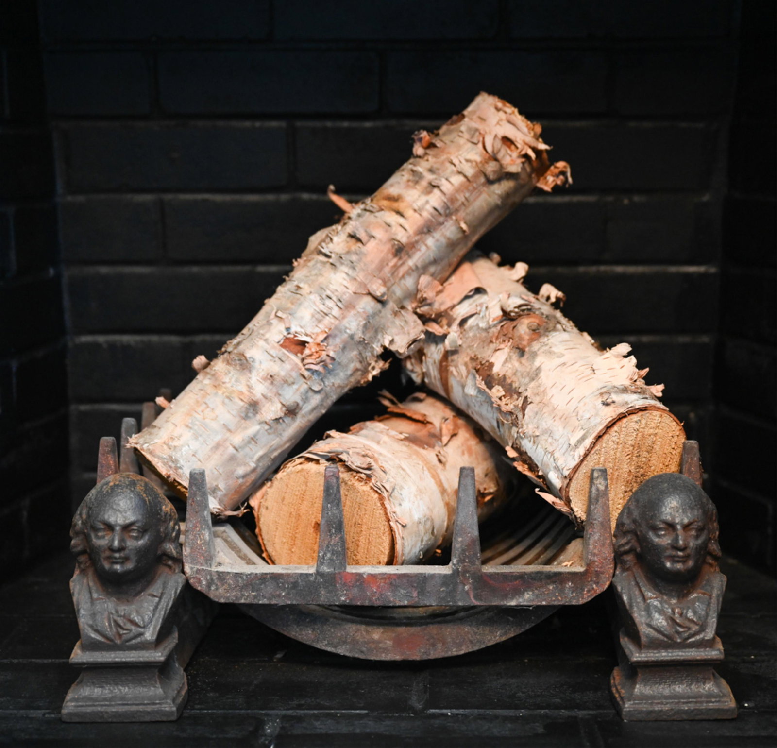 BEN FRANKLIN ANDIRONS & LOG HOLDER: Andirons and log holder with Ben Franklin. Dimensions: (Overall) H 7" x W 19" x D 14" Condition: Wear consistent with use.