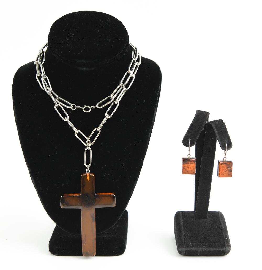 MODERNIST AMBER EARRINGS AND VOUGE CROSS: Including natural amber and sterling silver square earrings and a Vogue faux amber and silver tone necklace. Dimensions: L 28" x Drop: 4.25" Condition: Showing normal signs of light use.