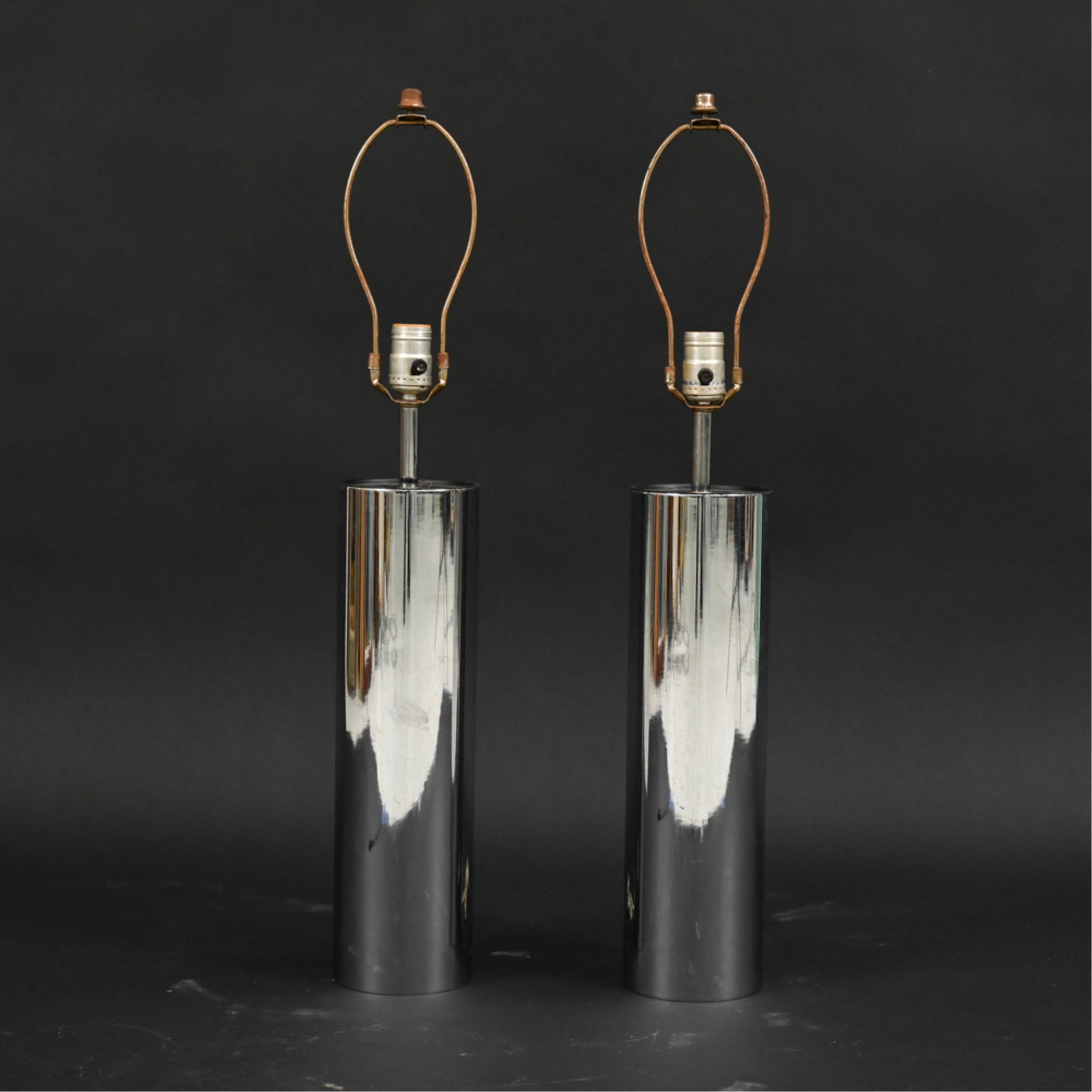 PAIR ATTR. GEORGE KOVACS CHROME TABLE LAMPS: Pair mod cylinder shape chrome lamps. Circa 1970. Dimensions: (To finial) H 29" x Dia. 4.5" Condition: Some rust and minor scratches. Not tested.