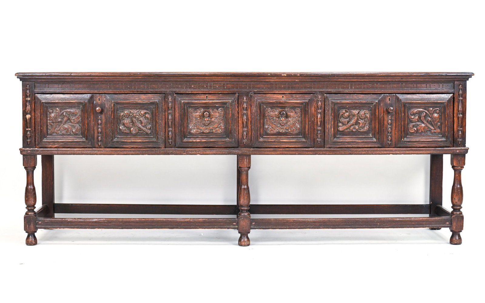 CHARLES II STYLE CONSOLE: Carved drawer fronts. Dimensions: H 32" x W 84.5" x D 22" Condition: Antique wear consistent with age and use including marks and wear to surface throughout, some loose trim pieces, losses.