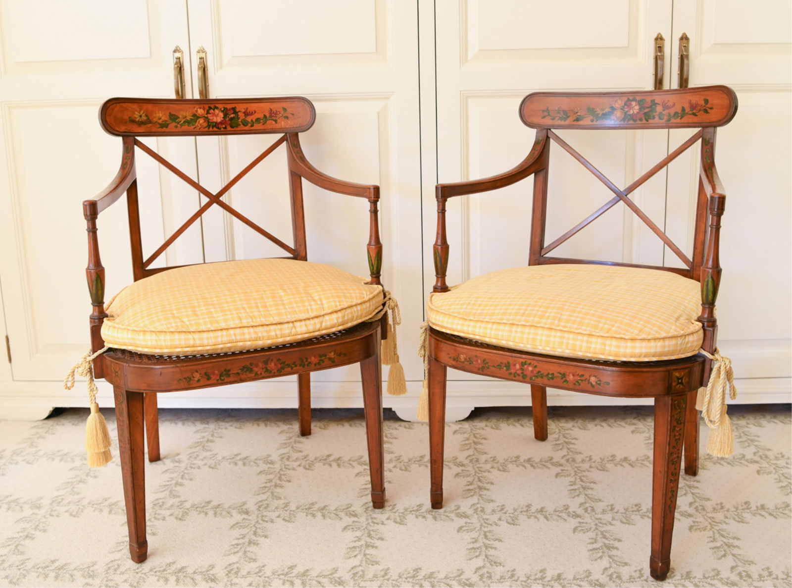 PAIR OF 20TH C. ARM CHAIRS IN ADAM STYLE: With floral painted decoration. Dimensions: H 33" x W 21.5" x D 21" SH 18" Condition: Nicks to legs and rubbing and paint loss on arm rests.