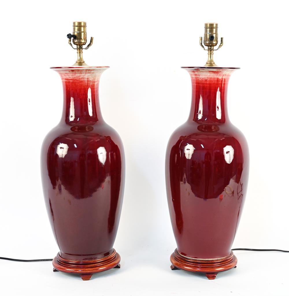 PAIR OF CHINESE SANG DE BOEUF VASES, AS LAMPS: Dimensions: H 24" x Dia. 9" Condition: Untested. Wear consistent with age and use including a few minor nicks and surface scratches to vases.