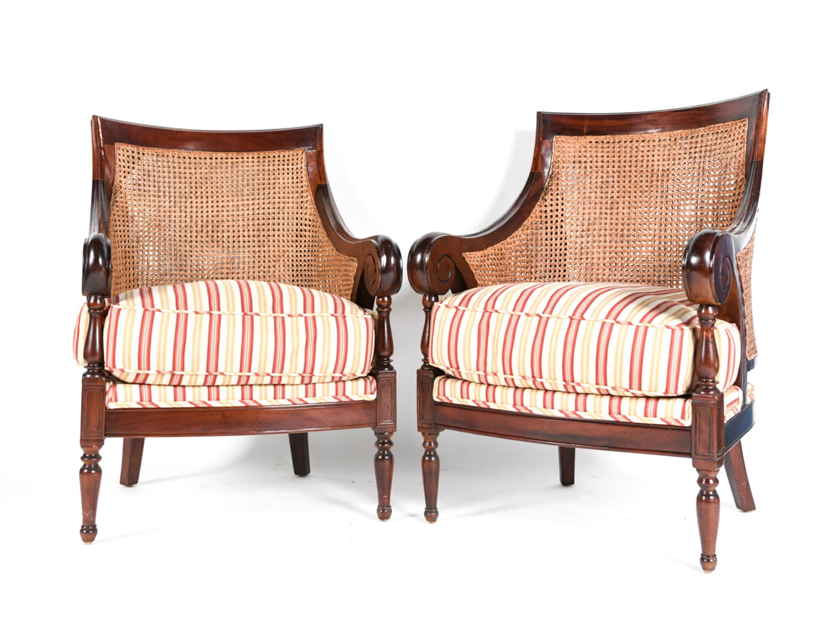 PAIR OF CANED LOUNGE CHAIRS: With fabric cushions. Dimensions: H 38" x W 26.5" x D 28.5" S.H. 20" Condition: Showing signs of wear including scratches and scuffs to wood finish. Soils and sun fading to seat upholstery.