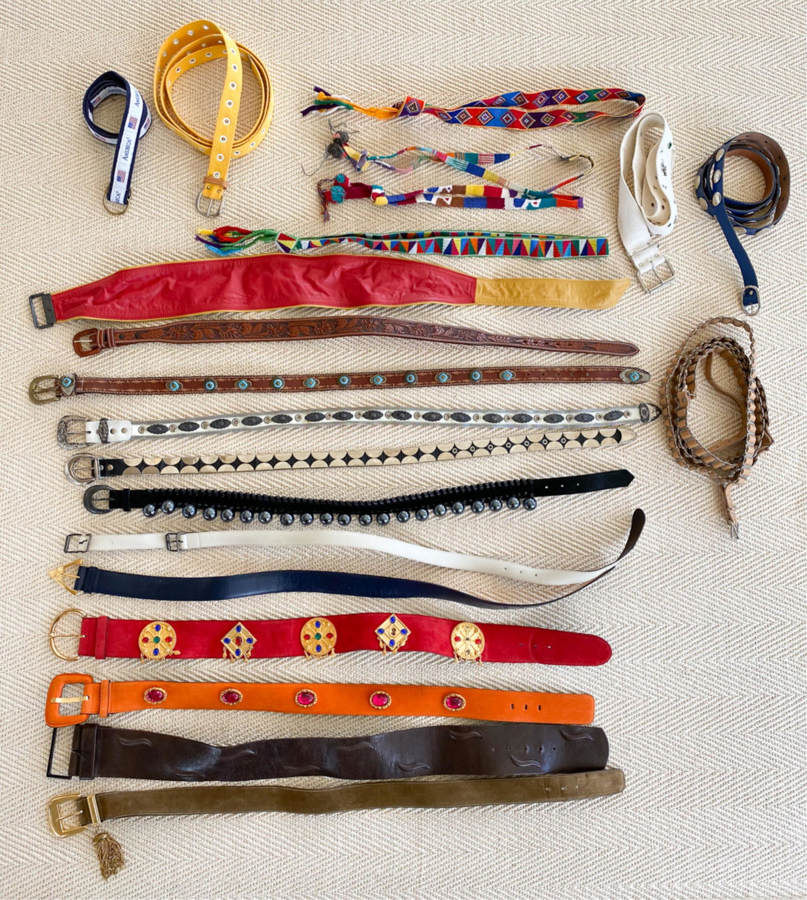 LADIES DESIGNER BELTS INCL. YSL, ESCADA, VERSACE: (21) belts. Including (2) vintage jeweled suede Escada belts, Yves Saint Laurent black suede belt with metal beads, vintage Gianni Versace white leather double buckle belt, etc. Dimensions: (Widest) L