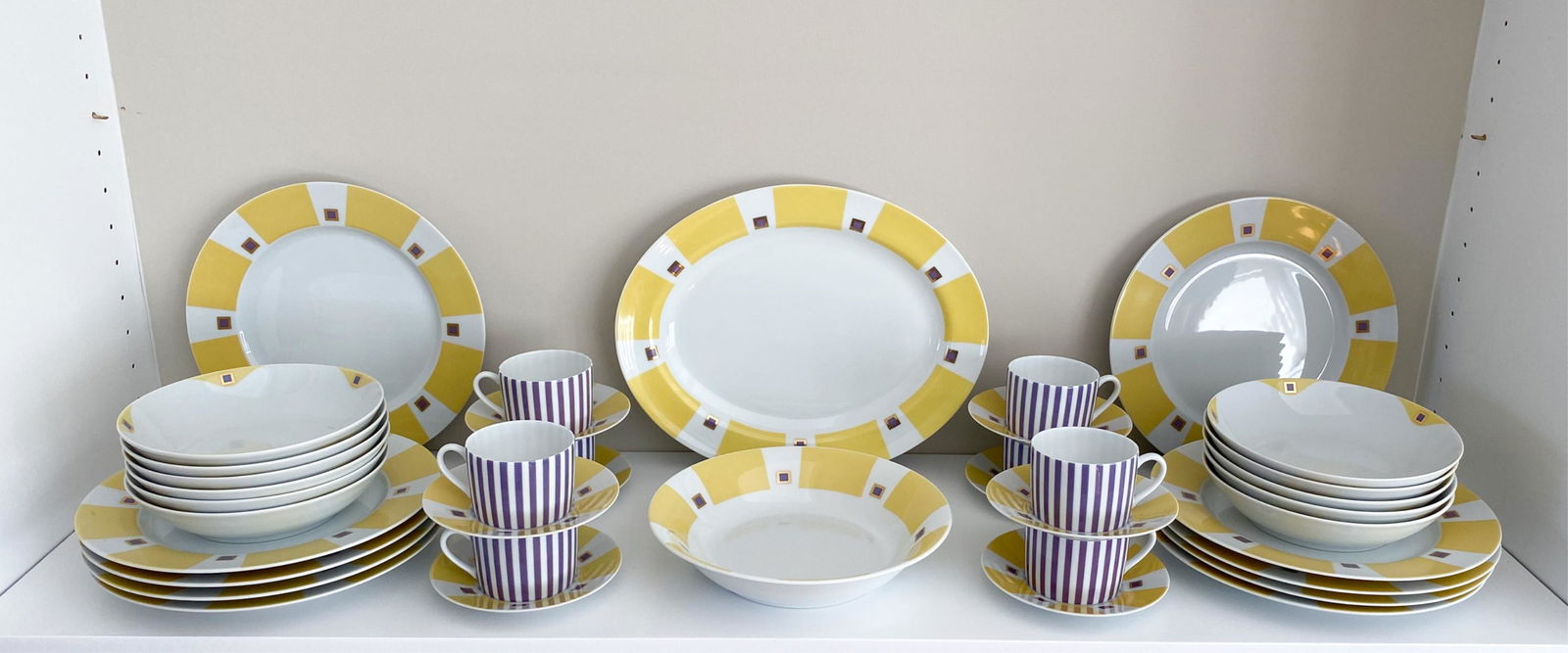 BERNARDAUD LIMOGES MIKADO SERVICE: Marked underneath: Bernardaud Limoges, Mikado 1993. Including: (10) plates, one serving bowl, one serving platter, (11) bowls, (8) teacups and (8) saucers. Dimensions: (Largest) L 10.5" x W 13" Condit