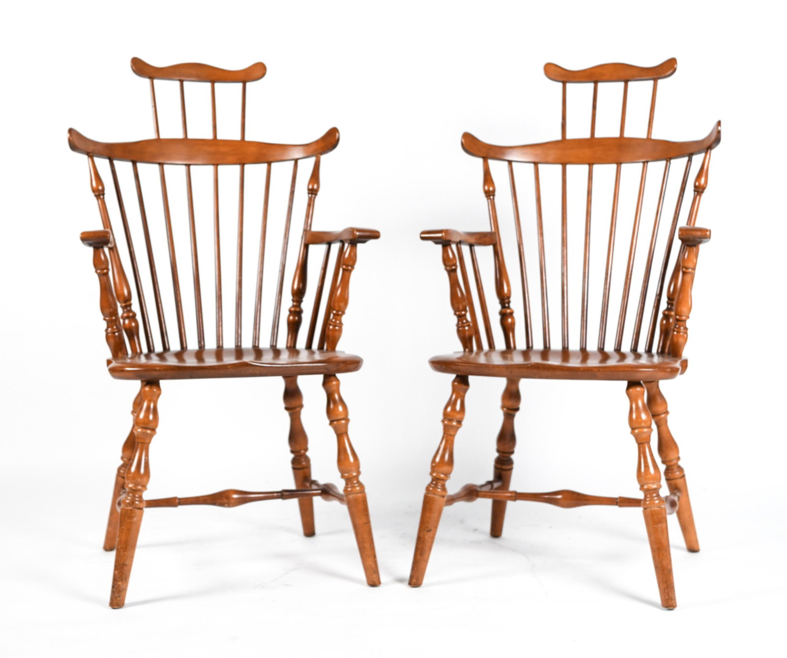PAIR WHITNEY HERITAGE HIGH-BACK WINDSOR ARMCHAIRS: Stenciled under seat. Dimensions: H 42.5” x W 22.5” x D 26” x SH 17.5” Condition: Wear consistent with normal use including scratches and nicks throughout; one seat with moderate scuffs and fi