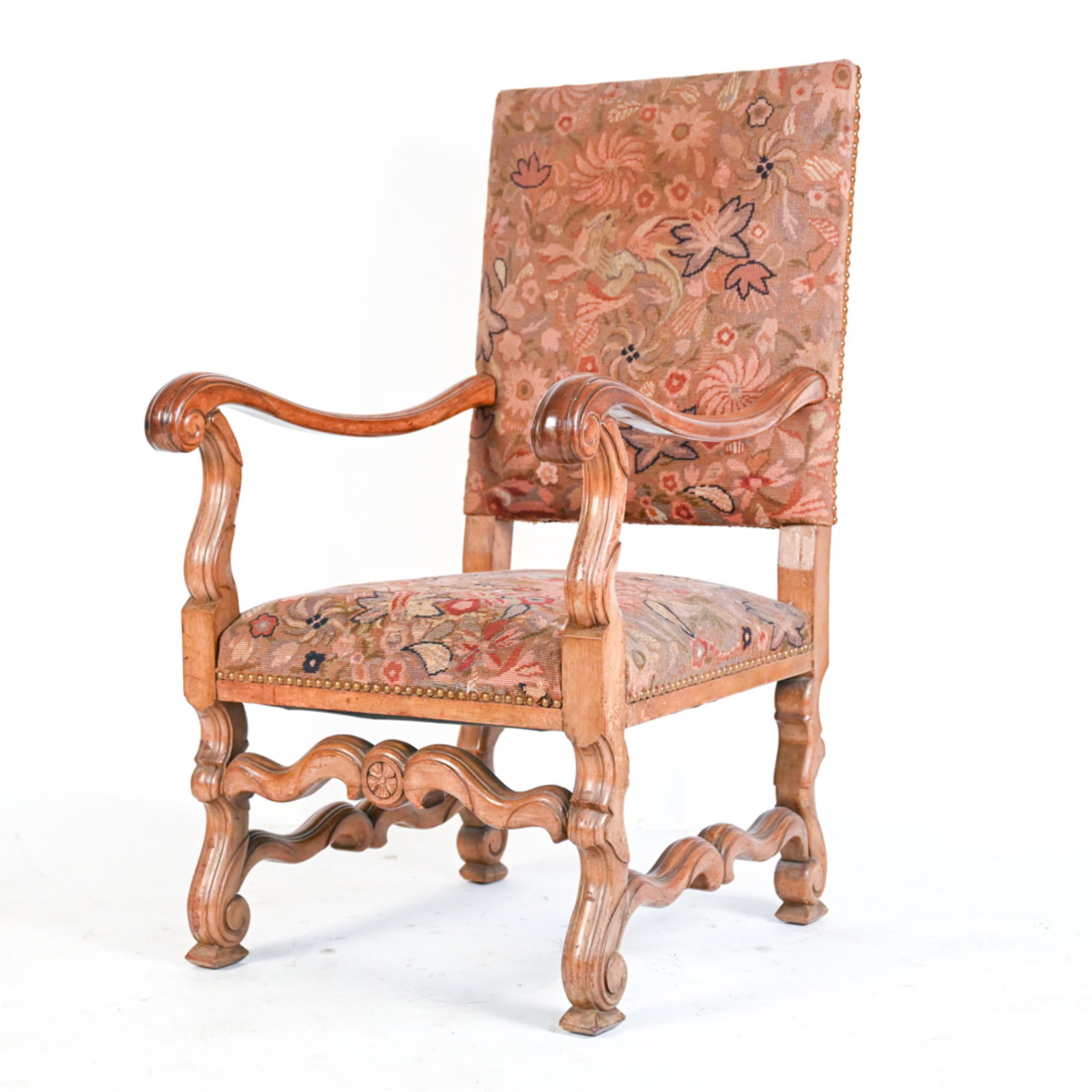 LOUIS XIV STYLE ARMCHAIR: Hand-carved fruitwood upholstered in wool tapestry. Dimensions: H 46" x W 25" x D 29.5" x SH 18" Condition: Backing of upholstery with some tears, discoloration, torn to back left seam. Some wear and 