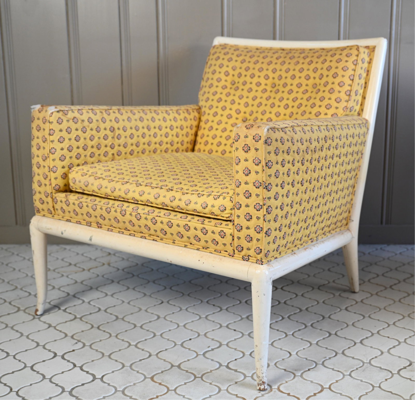 T. H. ROBSJOHN GIBBINGS LOUNGE CHAIR: Yellow pleated chair with flowers on wooden base. Dimensions: H 30" x W 28" x D 31" SH 18" Condition: Rip to front of arm rests. Losses to paint on wood frame. Separation at joints. Nicks dings and sc