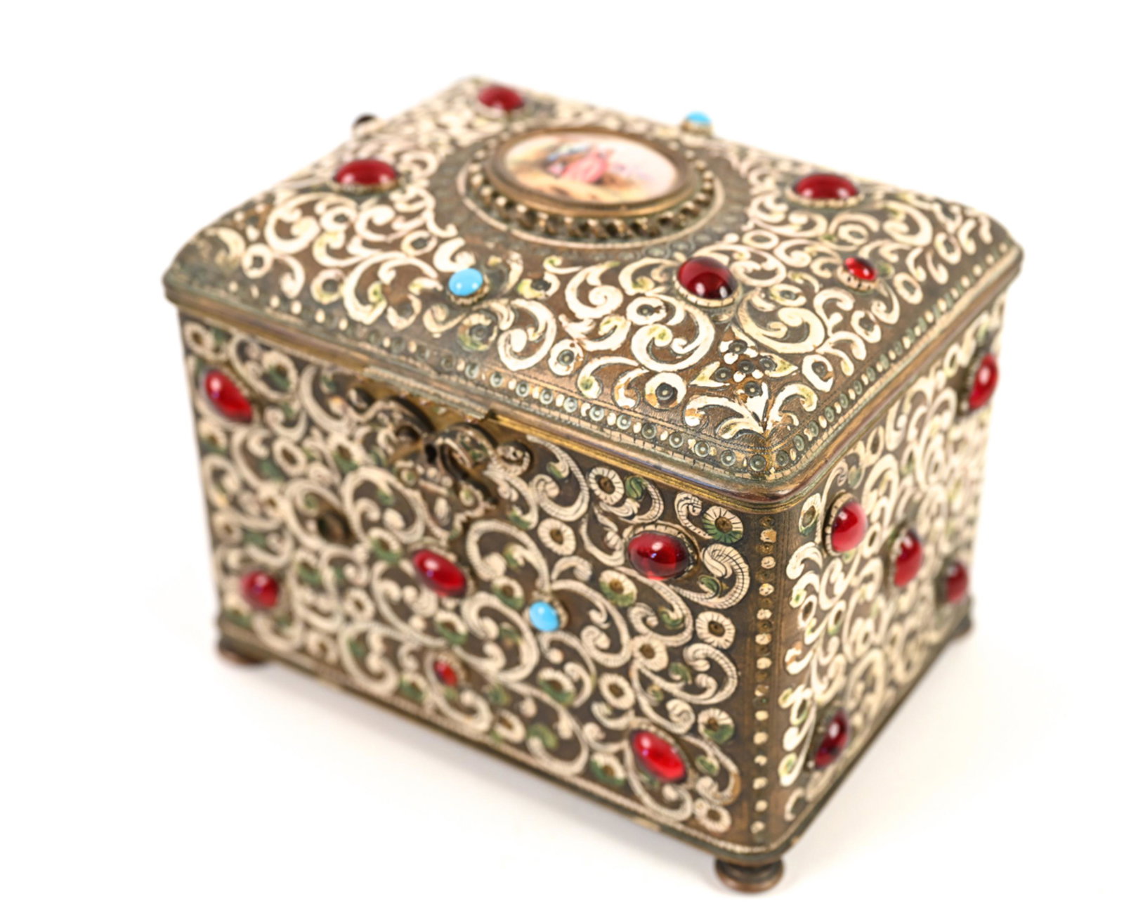 AUSTRAIN PAINTED & JEWELED BRASS BOX: With painted porcelain figural plaque to top. Glass jewels. Dimensions: H 6.25" x W 6.5" x D 9" Condition: Soiling and tattering to interior lining. Paint losses. Missing jewel to front.