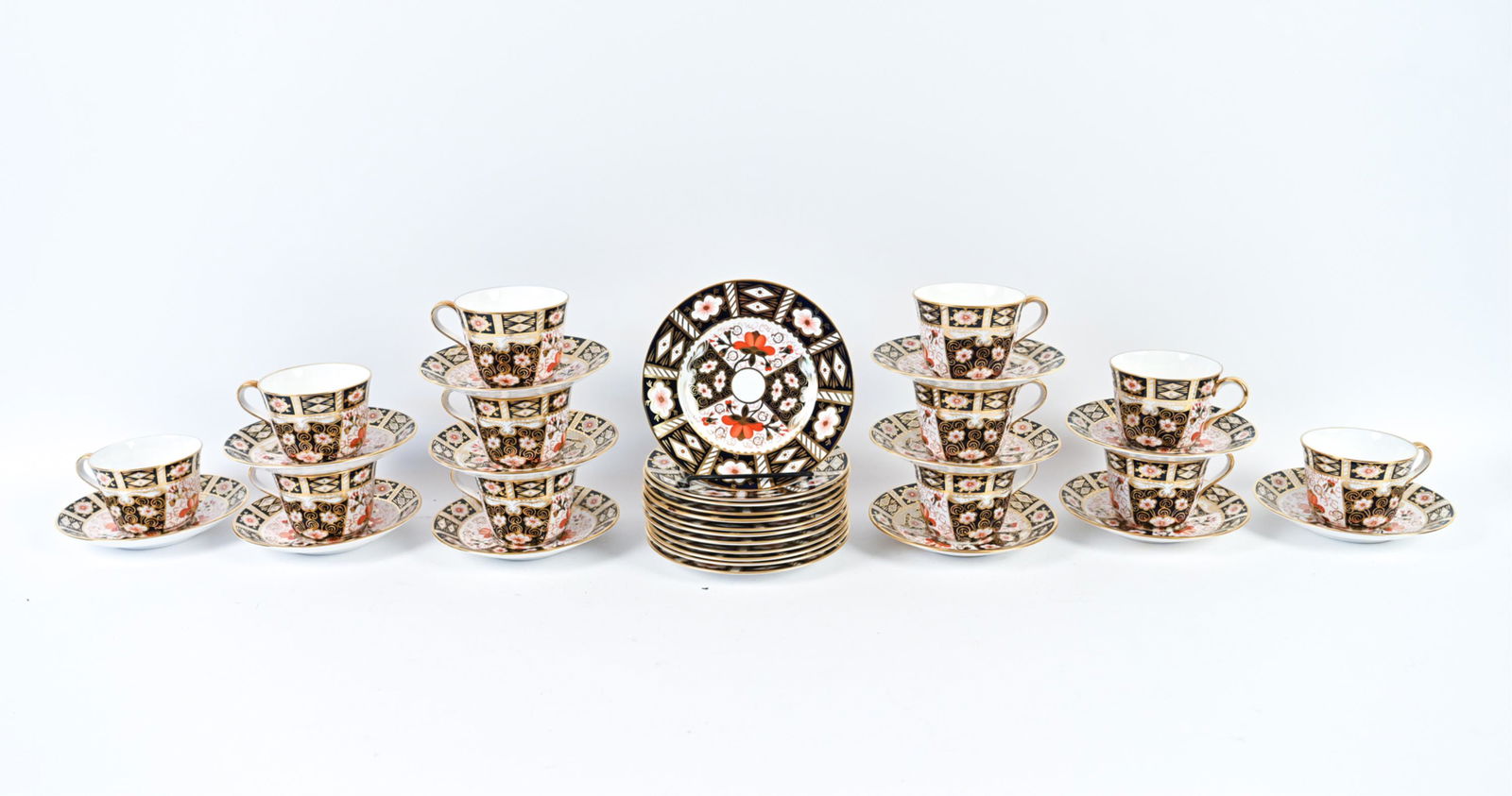 ROYAL CROWN DERBY BONE CHINA TEA SERVICE: Marked underneath. (5) coffee cups, (12) teacups, (12) 5.75" saucers, and (12) 6.25" plates. Dimensions: (Larger plate) Dia. 6.25" Condition: One smaller saucer cracked. Some minor rubs to gold. Few s