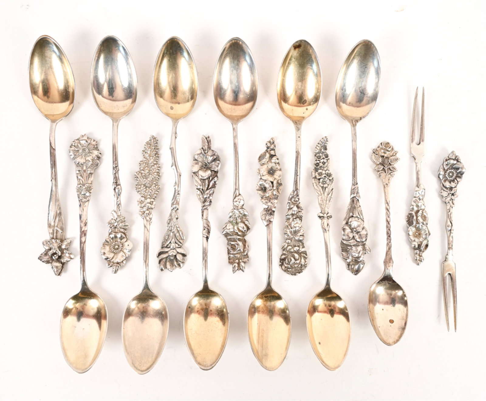 STERLING ART NOUVEAU REPOUSSE SPOONS & FORKS: With art nouveau floral motif handles, marked sterling, hallmarked. (14) pieces including (12) spoons and (2) two-prong forks. Dimensions: (Longest) L 5" Weight: (Total) 7.760 ozt Condition: Some tarn
