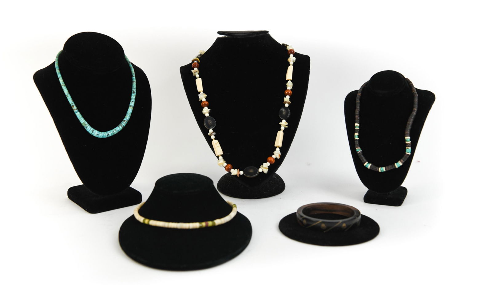 NATIVE AMERICAN JEWELRY INCL TURQUOISE: (4) necklaces consisting of bone, shell, turquoise, etc and a wood and brass inlaid bangle bracelet. Dimensions: L 16.5" x Dia: 0.25" Condition: Vintage, some loosely strung.