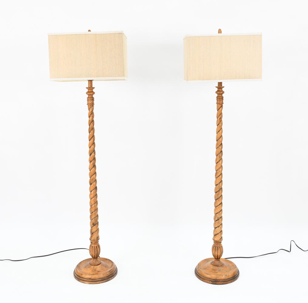 PAIR OF CARVED WOOD BARLEY TWIST FLOOR LAMPS: Fine pair of contemporary carved wood floor lamps with antiqued finish and rectangular woven grass shades. Dimensions: (With shade) H 58.5" x W 16" x D 10" Condition: Lamps untested. Intentionally dis