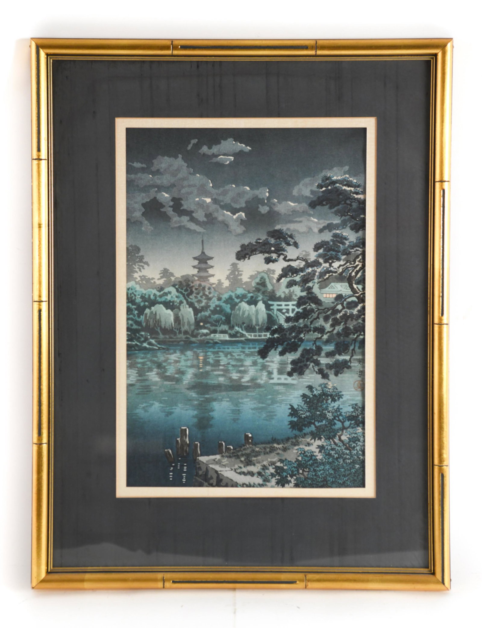 TSUCHIYA KOITSU, JAPAN (1883-1957) COLOR WOODBLOCK: Color woodblock print of temple viewed across a lake, signed mid-right. Dimensions: (Frame) H 23" x W 17.5", (Sight) H 15" x W 10" Condition: Wavy in frame. Age toning to mat. Some rubbing to frame.