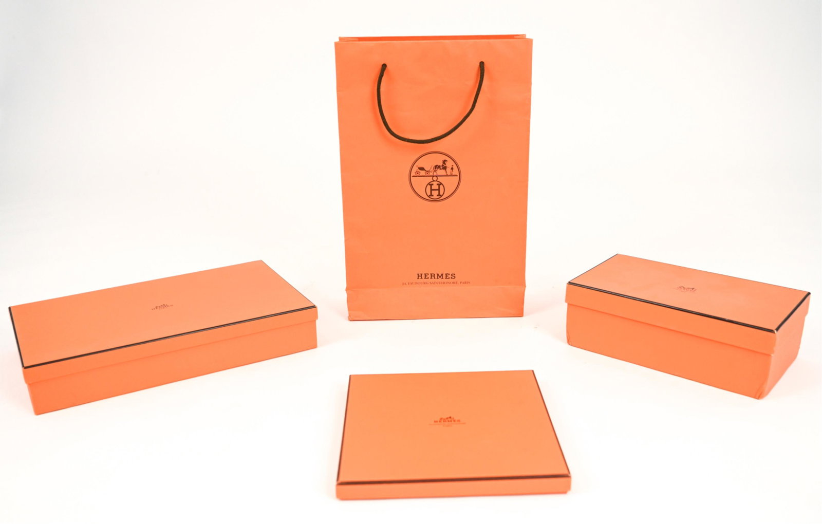 GROUPING OF HERM?S BOXES & SHOPPING BAG: Including shoe box, scarf box, sweater box, and tall shopping tote bag. Dimensions: (Bag) H 17" x W 11" x D 4" Condition: Showing signs of wear including small tear to corner of shopping bag, wear to 