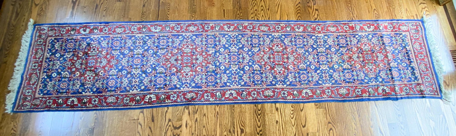 RUNNER RUG: Dimensions: W 142" x D 29" Condition: Light fading and spots of soiling. Minor losses and fraying to edges. Some tassels missing. May need cleaning.