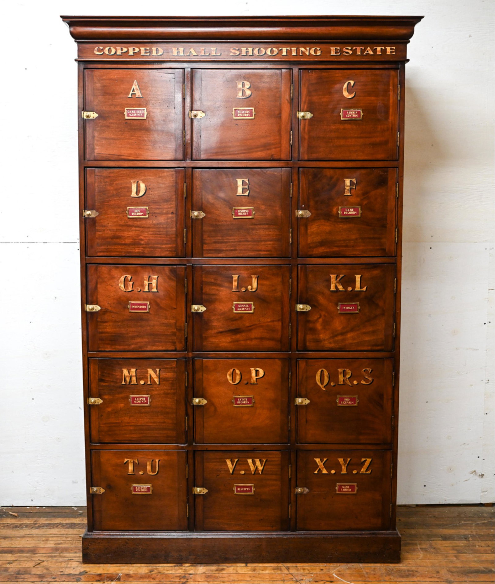 EDWARDIAN SHOOTING CABINET: With stenciled lettering and labels. Dimensions: H 81.5" x W 51" x D 18" Condition: Wear consistent with age and use. Nicks, scratches to finish with slight joint separation to crown.