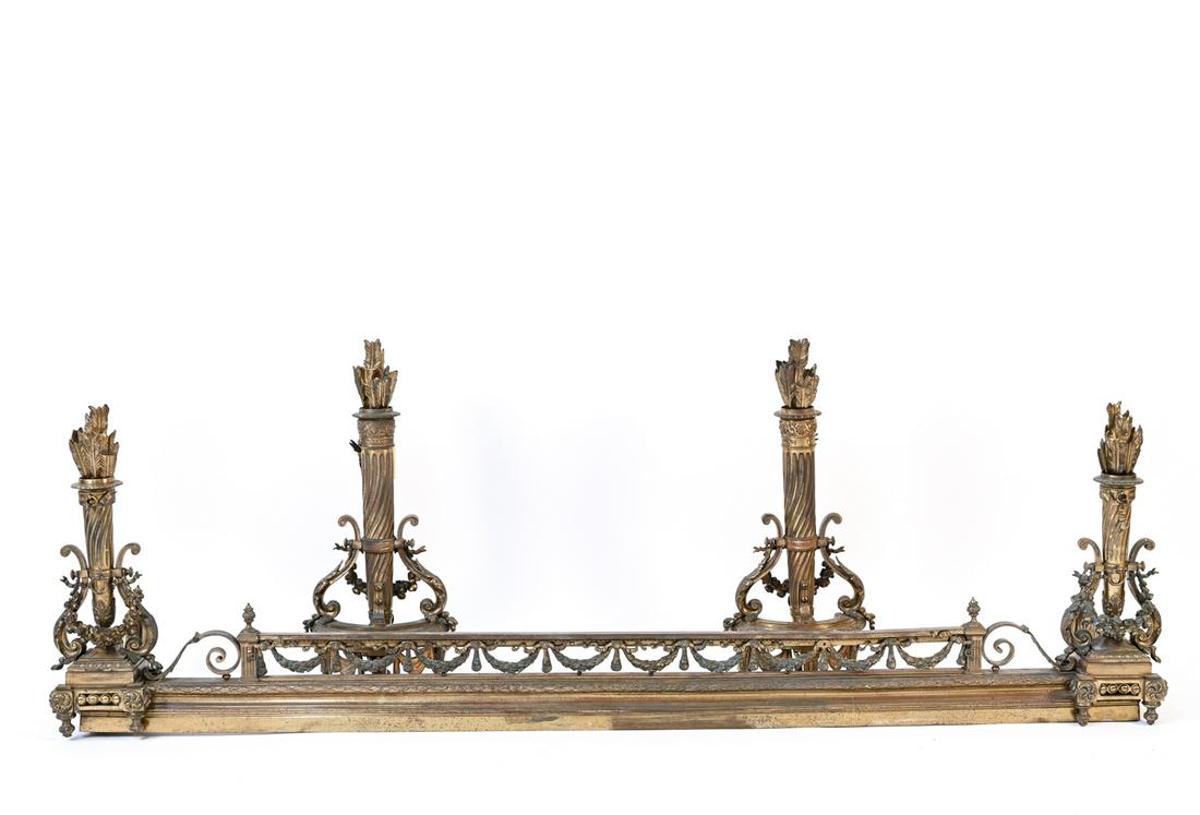 NEOCLASSICAL STYLE FIRE FENDER AND ANDIRONS: Dimensions: (Fender) H 23" x W 76" x D 13" Condition: Wear consistent with age and fire place exposure. Patina to finish. Nicks and dents to surface. some new screws.