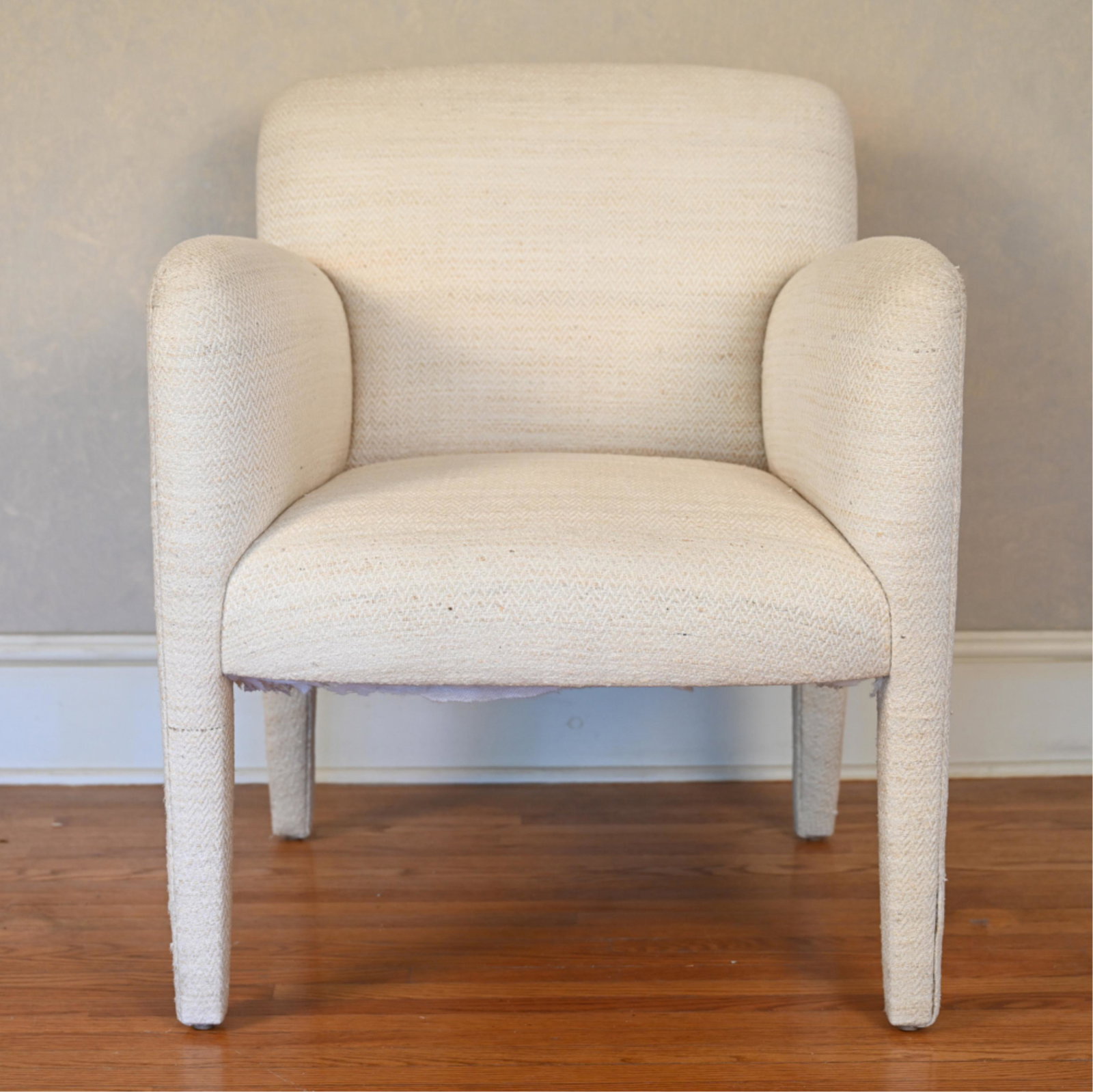 1980'S DONGHIA "NORWAY" DECO ARMCHAIR: Fully upholstered in light woven fabric. Dimensions: H 32.75" x W 27" x D 28" x SH 18" Condition: Showing normal wear including a few spots of discoloration to fabric, minor pilling and a few pulled t