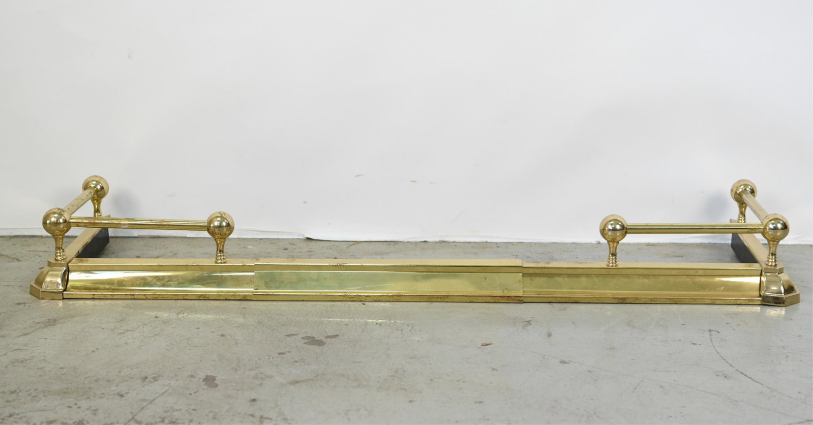 CONTEMPORARY BRASS EXTENDING FIRE FENDER: Dimensions: (Smallest) H 6" x W 54" x D 15" Condition: Some pitting, tarnishing, denting.