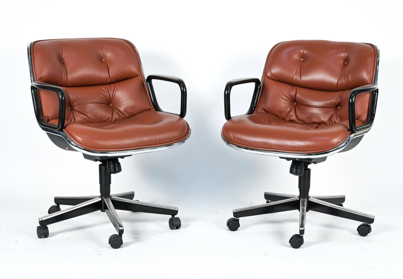 CHARLES POLLOCK EXECUTIVE LEATHER ARM CHAIRS: Labeled underneath Knoll.On casters. Dimensions: H 33.5" x W 26" x D 29" S.H. 20.5" Condition: Wear consistent with age and use including few scuffs to leather and light oxidation to chrome.