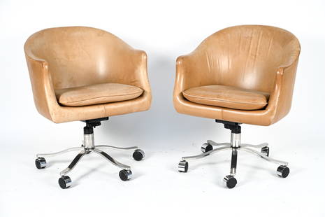 PAIR OF NICOS ZOGRAPHOS ARM CHAIRS ON CASTERS: Stamped bottom of leg. Leather upholstery. Dimensions: H 31.5" x W 24.5" x D 27" S.H. 19" Condition: Showing wear including water marks, scratches and scuffs to leather as shown in photos. light oxida