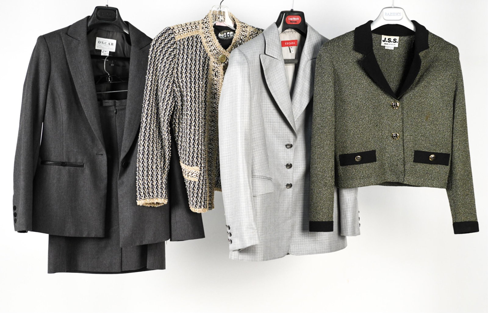 GROUPING OF WOMEN'S DESIGNER CLOTHES: Including Oscar de la Renta two piece skirt suit (top size 4, skirt size 6), Basler sparkly jacket (size 34), Escada blazer (size 36), and JSS blazer (petite). Condition: Gently used. Some soiling.