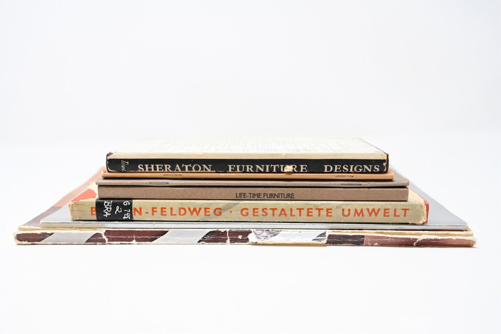 (7) VINTAGE FURNITURE & DESIGN BOOKS INCL STICKLEY: Group of (7) vintage furniture and design publications, including: "Sheraton Furniture Designs" (Pub. Alec Tiranti 1949); "Gestaltete Umwelt: Haus, Raum, Werkform" (Braun-Feldweg 1956) 1st. ed., "Desi