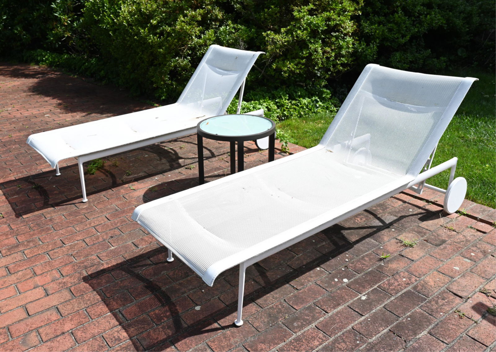 (2) RICHARD SCHULTZ CHAISE LOUNGES & SIDE TABLE: Side table marked Janus et Cie. Chaise marked Richard Schultz.Dimensions: (Lounge, upright) H 36" x L 77" x W 27" (Table) H 18" x Dia. 20.25" Condition: Wear consistent with outdoor exposure, one chai