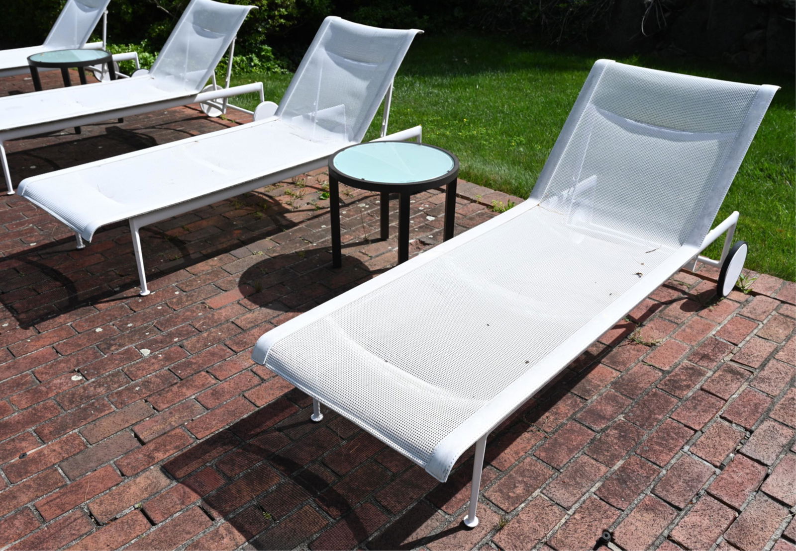 (2) RICHARD SCHULTZ CHAISE LOUNGES & SIDE TABLE: Side table marked Janus et Cie. Chaise marked Richard Schultz.Dimensions: (Lounge, upright) H 36" x L 77" x W 27" (Table) H 18" x Dia. 20.25" Condition: Wear consistent with outdoor exposure; rubbing,