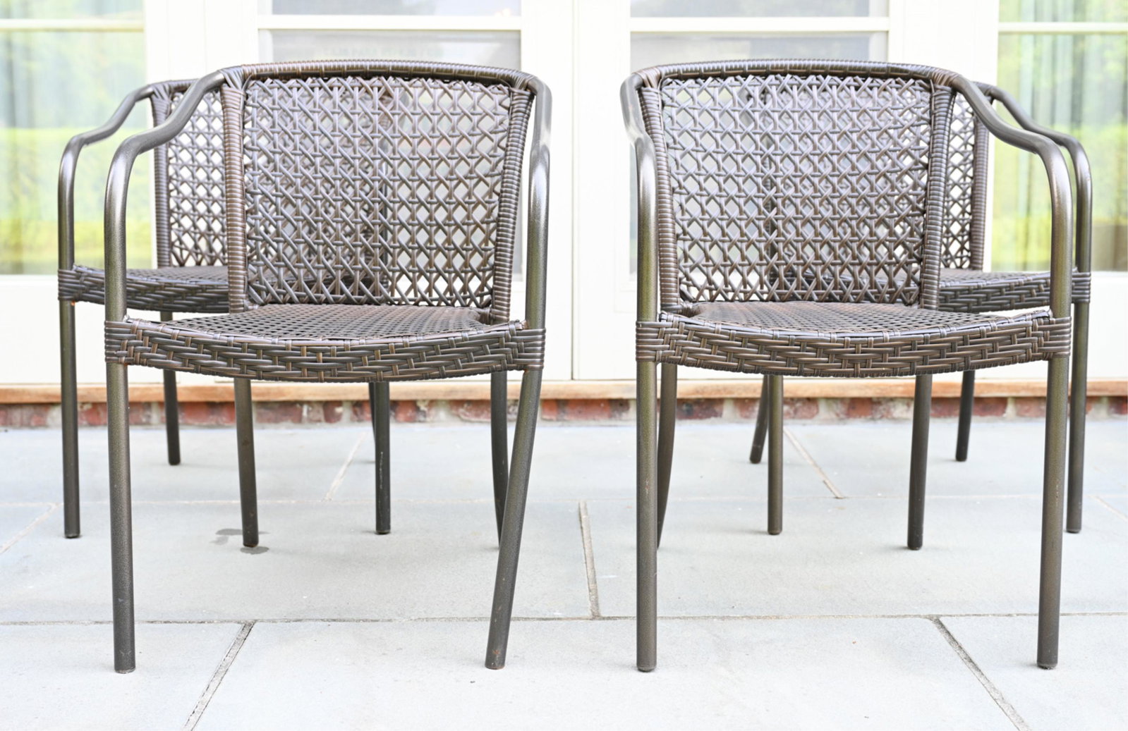 (4) FAUX WICKER OUTDOOR ARMCHAIRS: Apparently unmarked. Dimensions: H 30.25" x W 21" x D 21" x SH 16.5" Condition: Some rubbing and minor wear consistent with outdoor use.