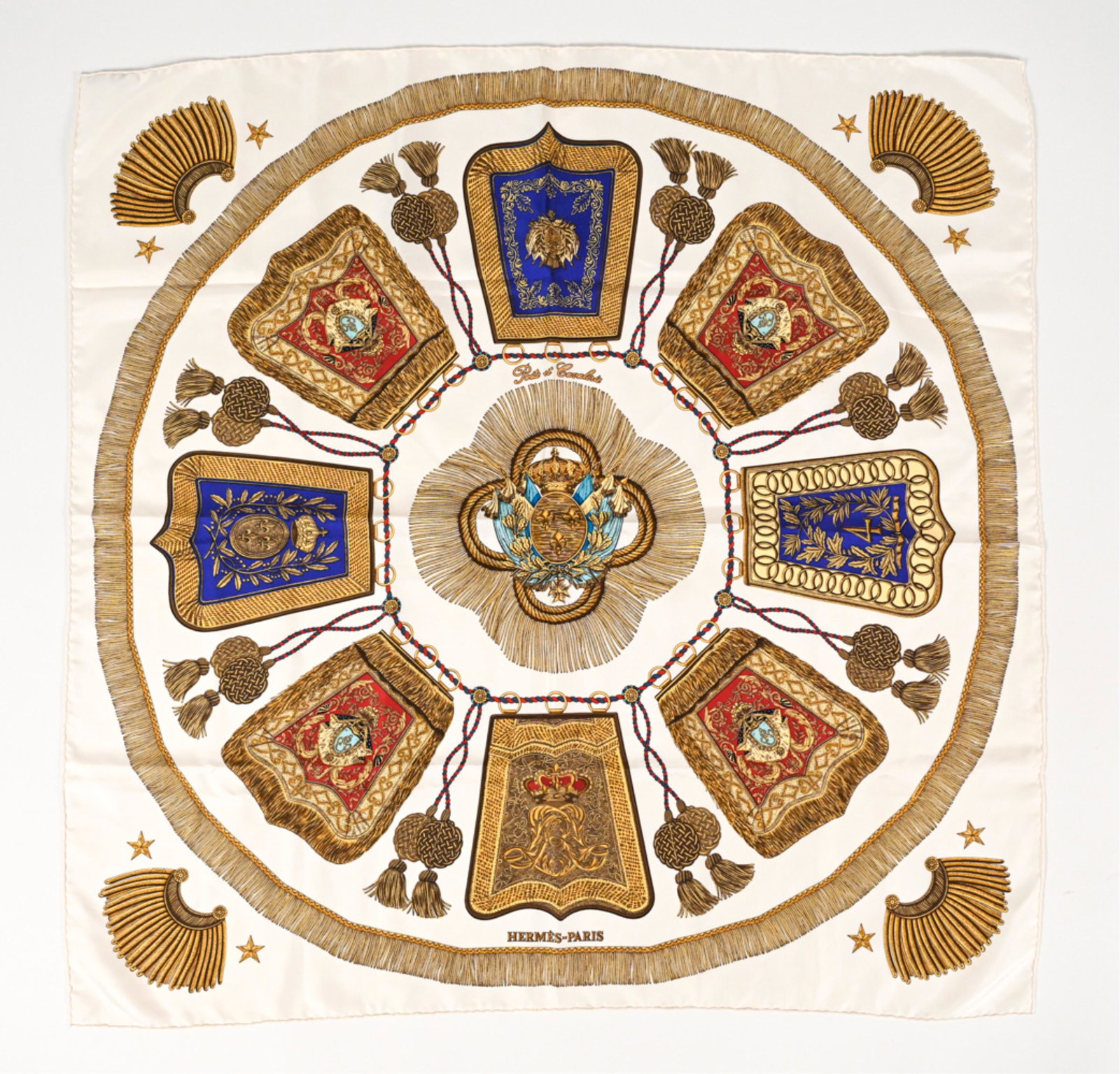 C. 1987 HERMES "POST ET CAVALERIE" SILK SCARF: Hermes "Post et Cavalerie" (Post and Cavalry) silk scarf, designed by Joachim Metz circa 1987. Features white colorway with gold tassels and coat-of-arms motifs. Titled upper center, with Hermes-Paris