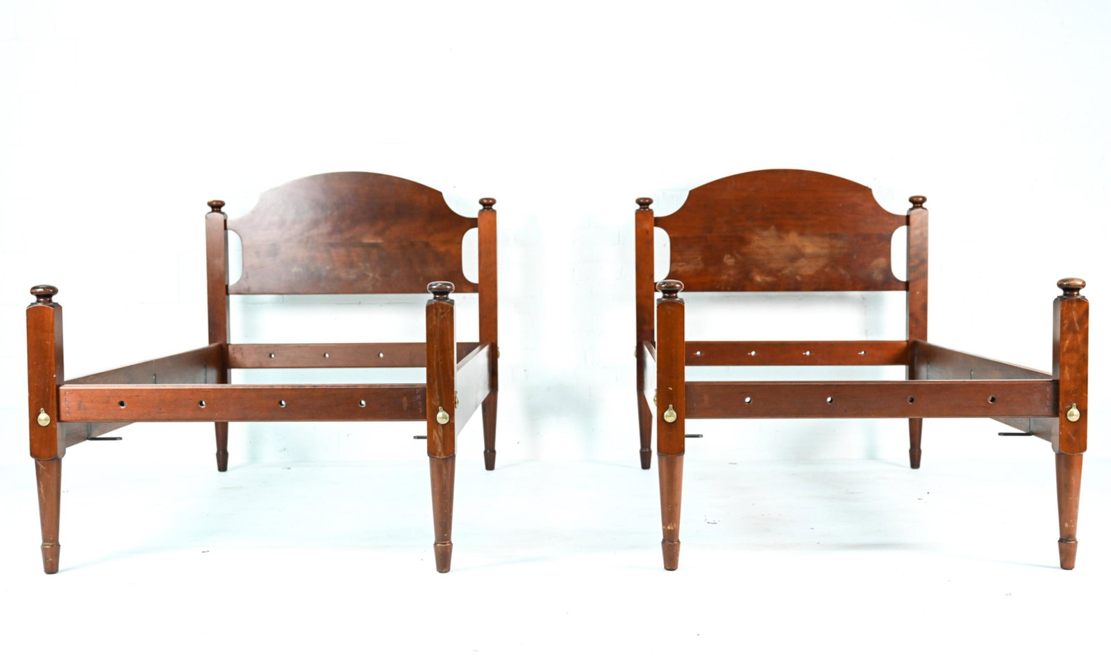 PAIR OF LEONARD'S TRADITIONAL TWIN BEDS: Marked Leonard's on back of headboard. Dimensions: (Each) H 44" x W 42.5" x L 80.5" Condition: Slats not included. Normal wear consistent with age and use, including scuffing and finish rubs to headbo