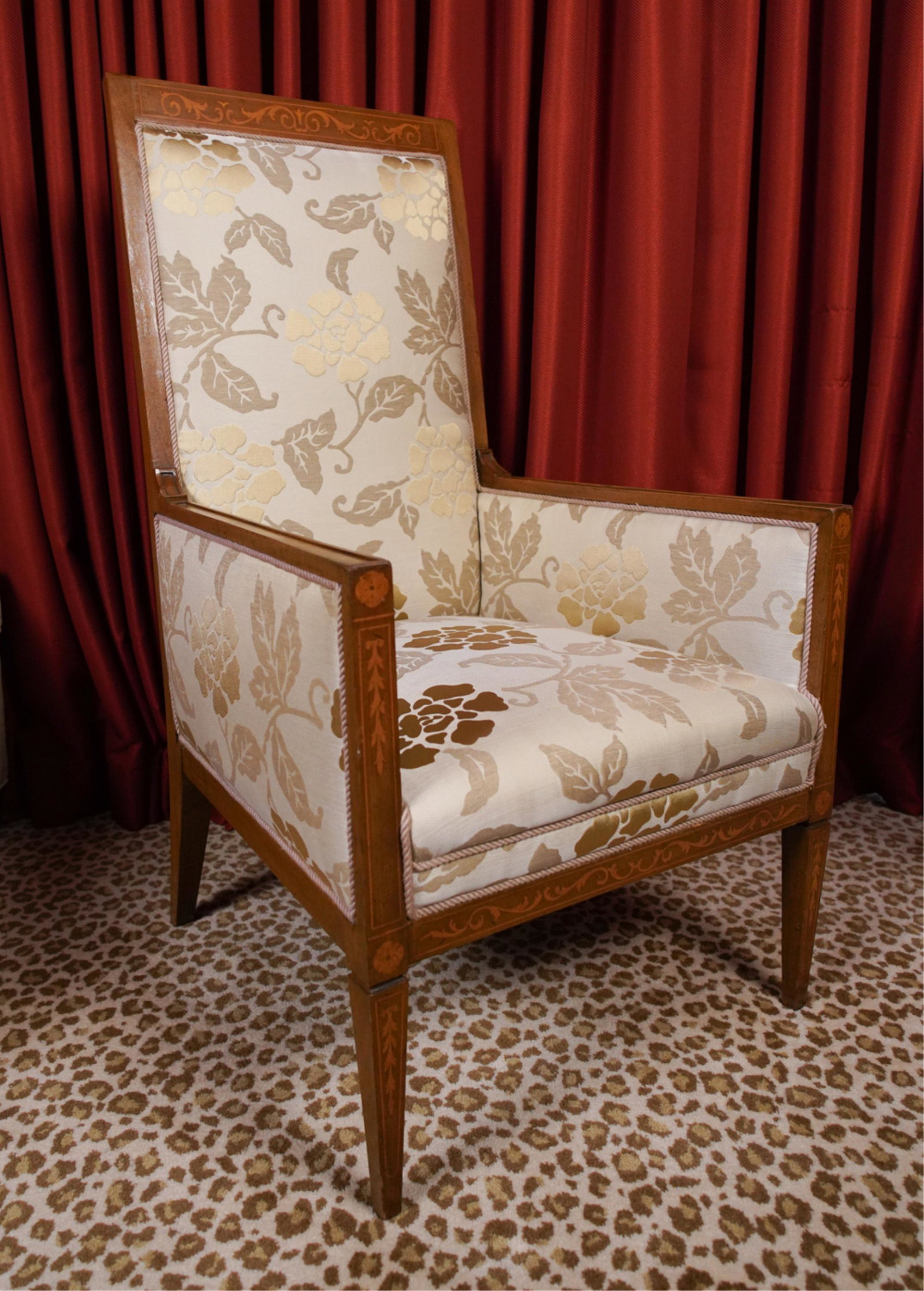 ANTIQUE LOUNGE CHAIR IN BOUSSAC FADINI FABRIC: Upholstered in Boussac Fadini fabric. With marquetry style inlay. Dimensions: H 44.5" x W 25" x D 28" x SH 17" Condition: Minor nicks, dings, and rubs to frame. Otherwise very good vintage condition.