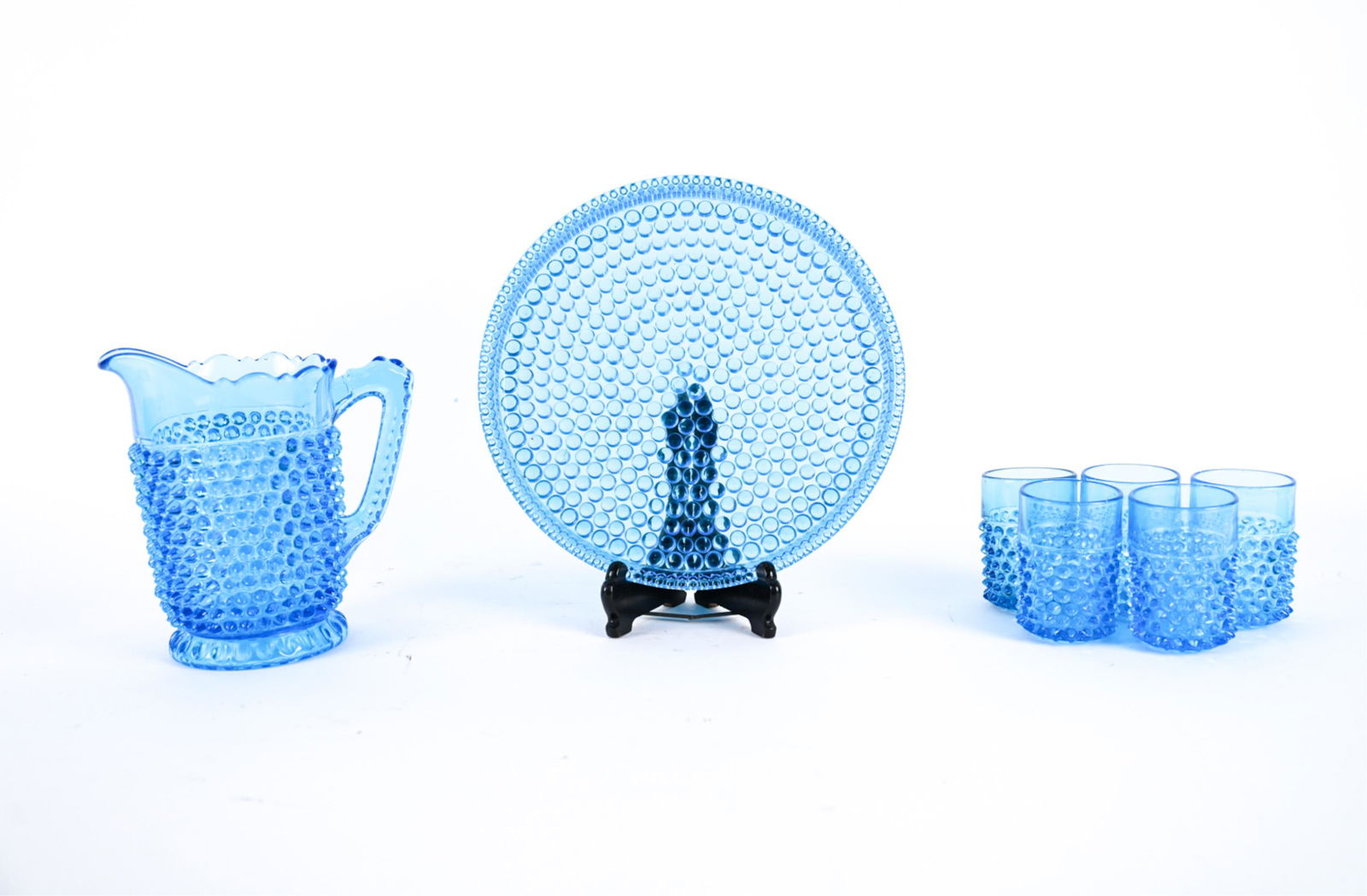 VINTAGE HOBNAIL GLASS DRINK SERVICE: Light blue. Includes platter, five glasses, and pitcher. Dimensions: (Pitcher) H 8.25" x W 8" x D 5" Condition: Couple edge marks.