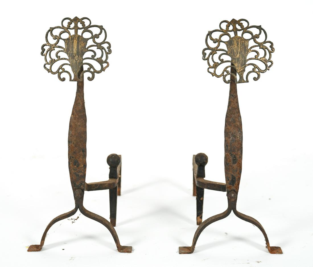 PAIR ANTIQUE ART NOUVEAU GOOSENECK ANDIRONS: Pair of gooseneck iron andirons with reticulated brass medallion heads, one with label remnant on leg. Dimensions: H 20" x W 16.5" x D 9" Condition: Wear consistent with age and use, including: one fi