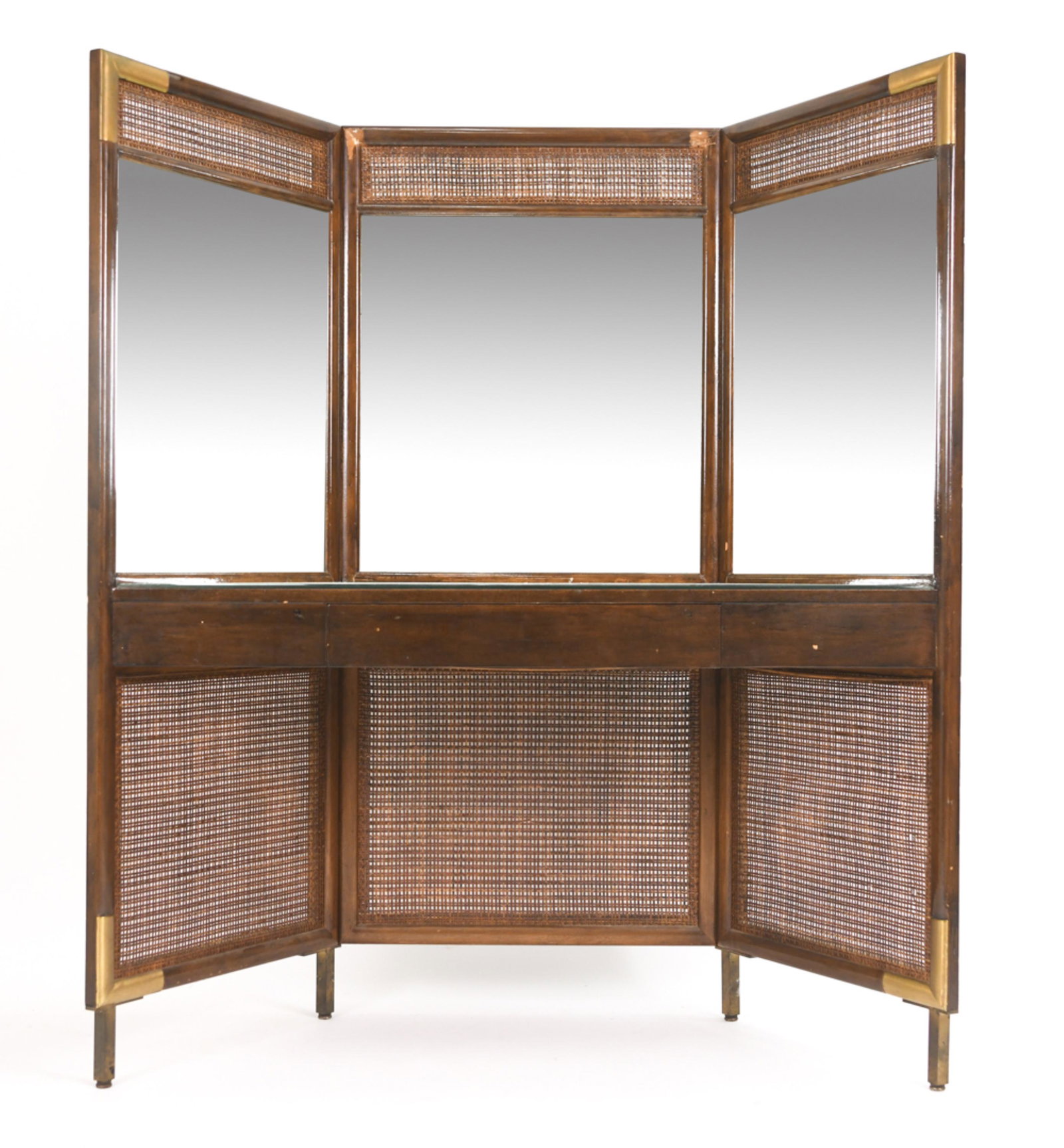 RARE LATE 1940'S GROSFELD HOUSE VANITY: An exceptional and rare Grosfeld House vanity in lacquered wood with caned panels, brass mounts, and mirrored tabletop. Grosfeld House plaque inside drawer. Dimensions: H 60.5" x W 51" x D 21" Conditi