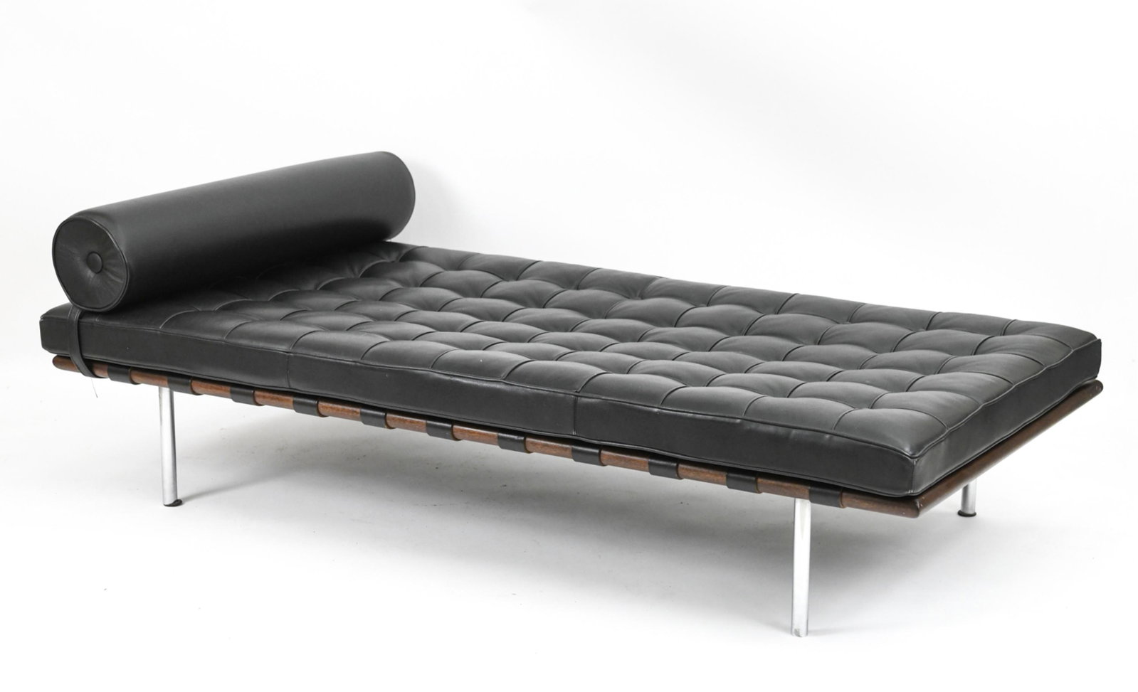DAYBED IN THE STYLE OF MIES VAN DER ROHE BARCELONA: Vintage daybed in walnut and chrome, with black genuine leather cushion and bolster. Apparently unlabeled. Dimensions: (Without cushion) H 12" x L 77" x W 38" Cushion height: 4" Condition: Showing lig
