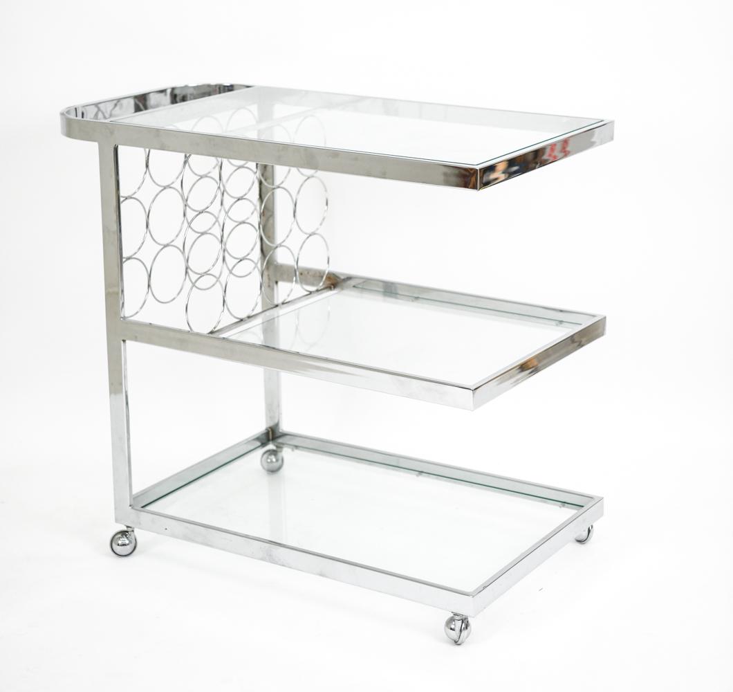 MILO BAUGHMAN STYLE CHROME BAR CART: Fantastic mod Milo Baughman style 3-tier Mid-Century chrome and glass bar cart. Holds 12 bottles of wine. Dimensions: H 31" x W 36" x D 19" Condition: Minor surface scratches. Chrome has a little rust