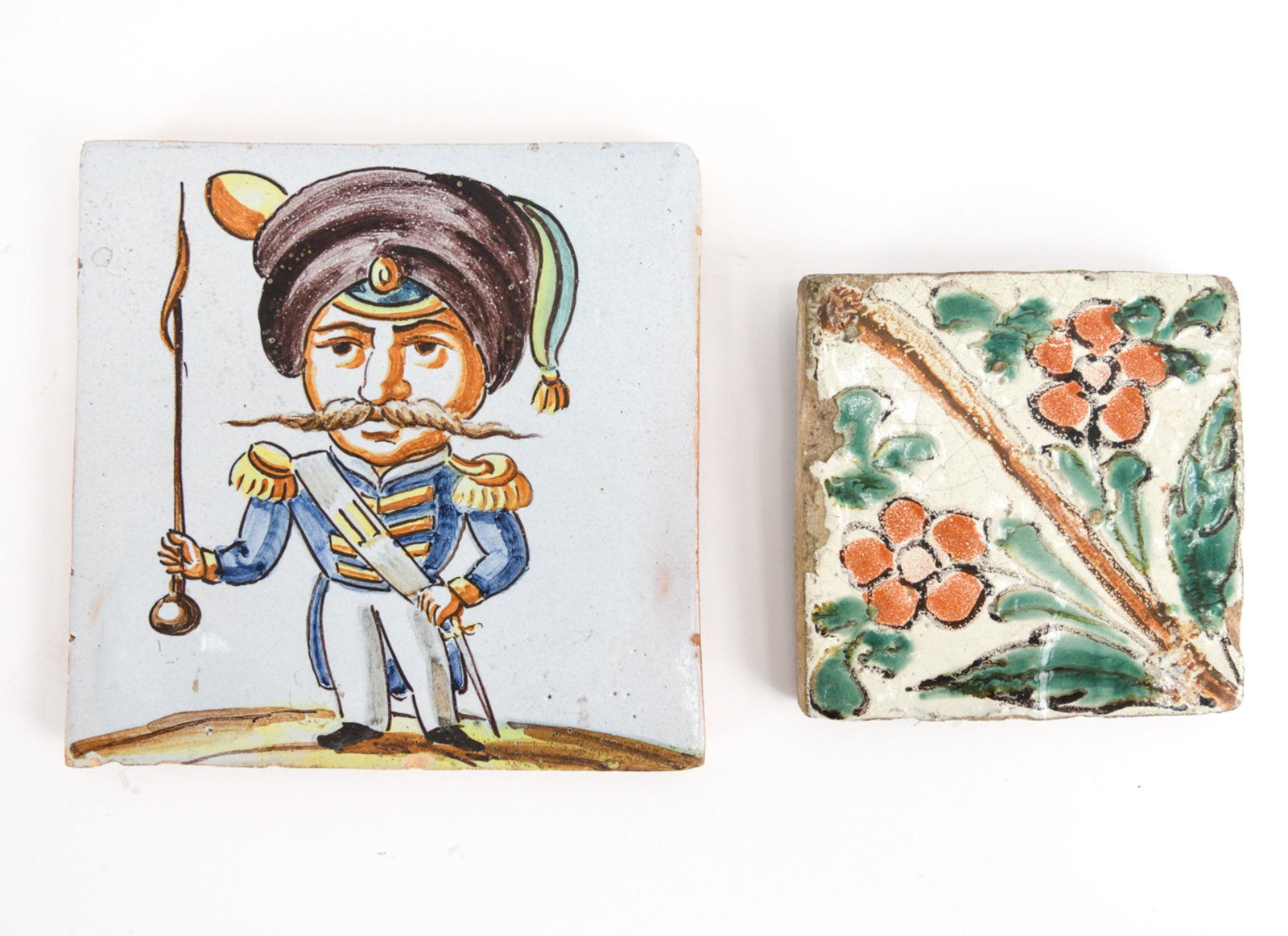 (2) ANTIQUE/VINTAGE TALAVERA POBLANA TILES: Including colorful 19th century and early 20th century of a soldier. Dimensions: (Larger) H 8" x W 8" Condition: Smaller tile with some edge losses. Felt backing with hooks for hanging.