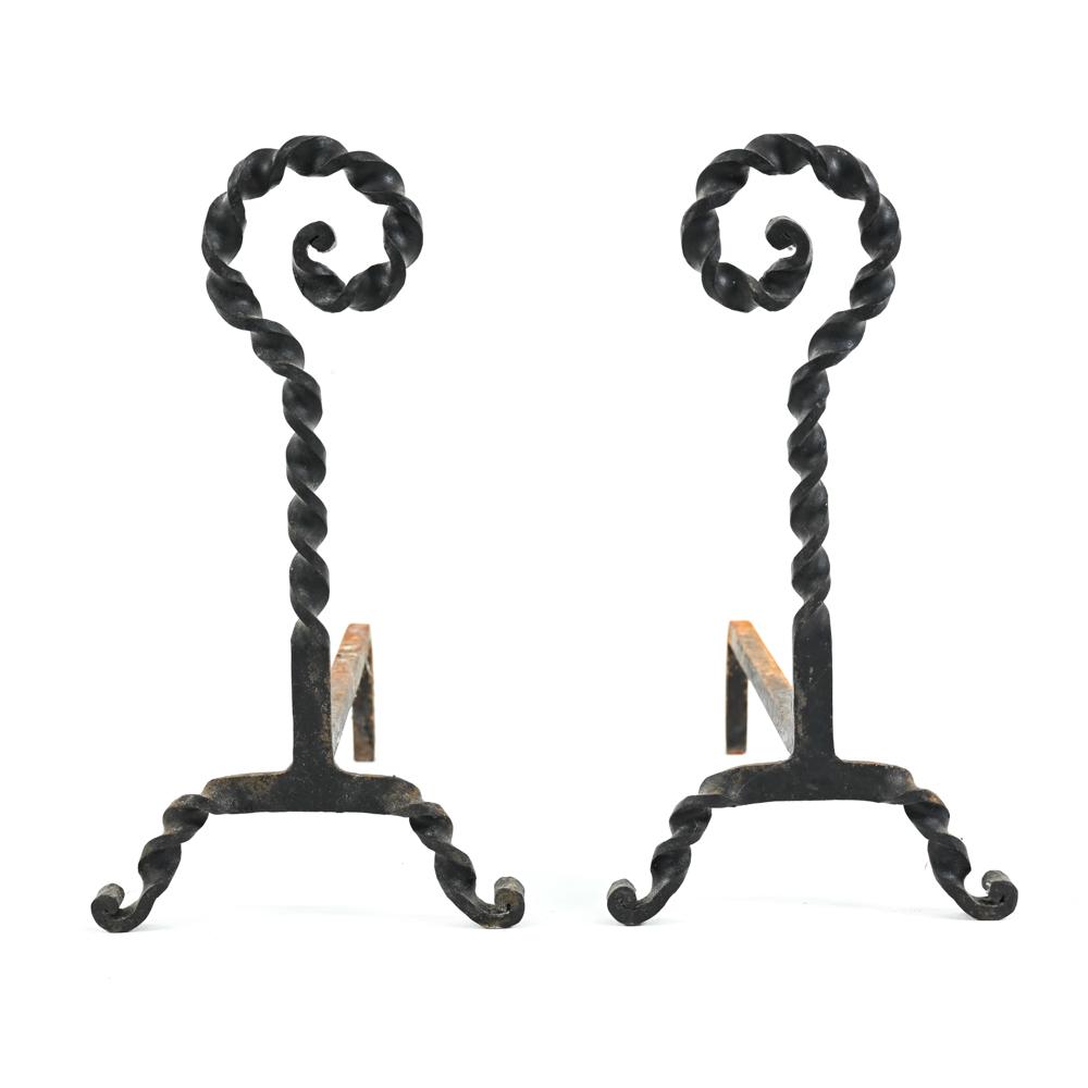 PAIR OF TWISTED WROUGHT IRON ANDIRONS: Pair of wrought iron andirons in twisted form. Dimensions: H 20.25" x W 11" x D 20.5" Condition: Showing signs of age and use including some oxidation.