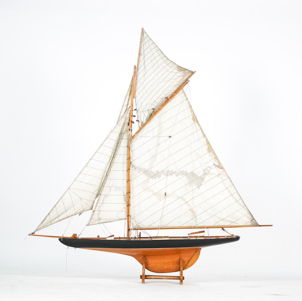 VINTAGE MODEL SAILING YACHT: Apparently unmarked, on fitted stand. Dimensions: (With stand) H 49" x W 47" x D 7" Condition: Showing signs of wear including soiling and water damage to sails, surface dirt, a few small splits to wo