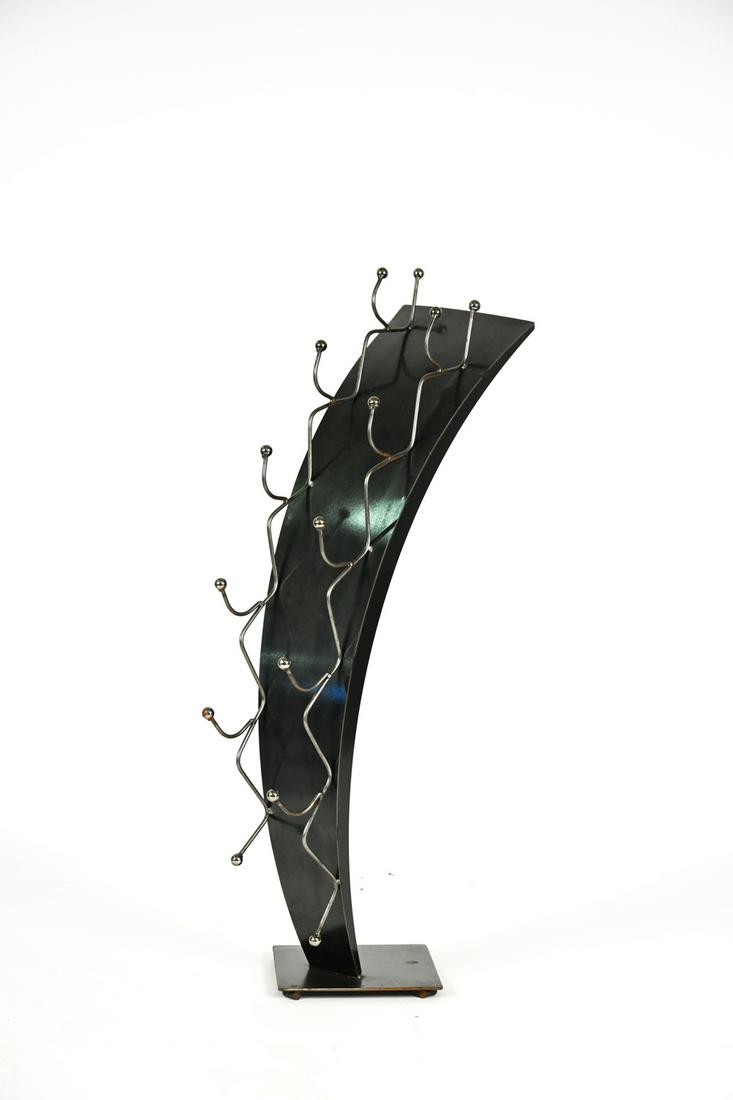 VINTAGE POSTMODERN METAL WINE RACK: Stamped M with 1999 copyright on base. Dimensions: H 44.5" x W 14" x D 19" Condition: Wear consistent with age and use including a few areas of rust, discoloration, and finish losses to metal.