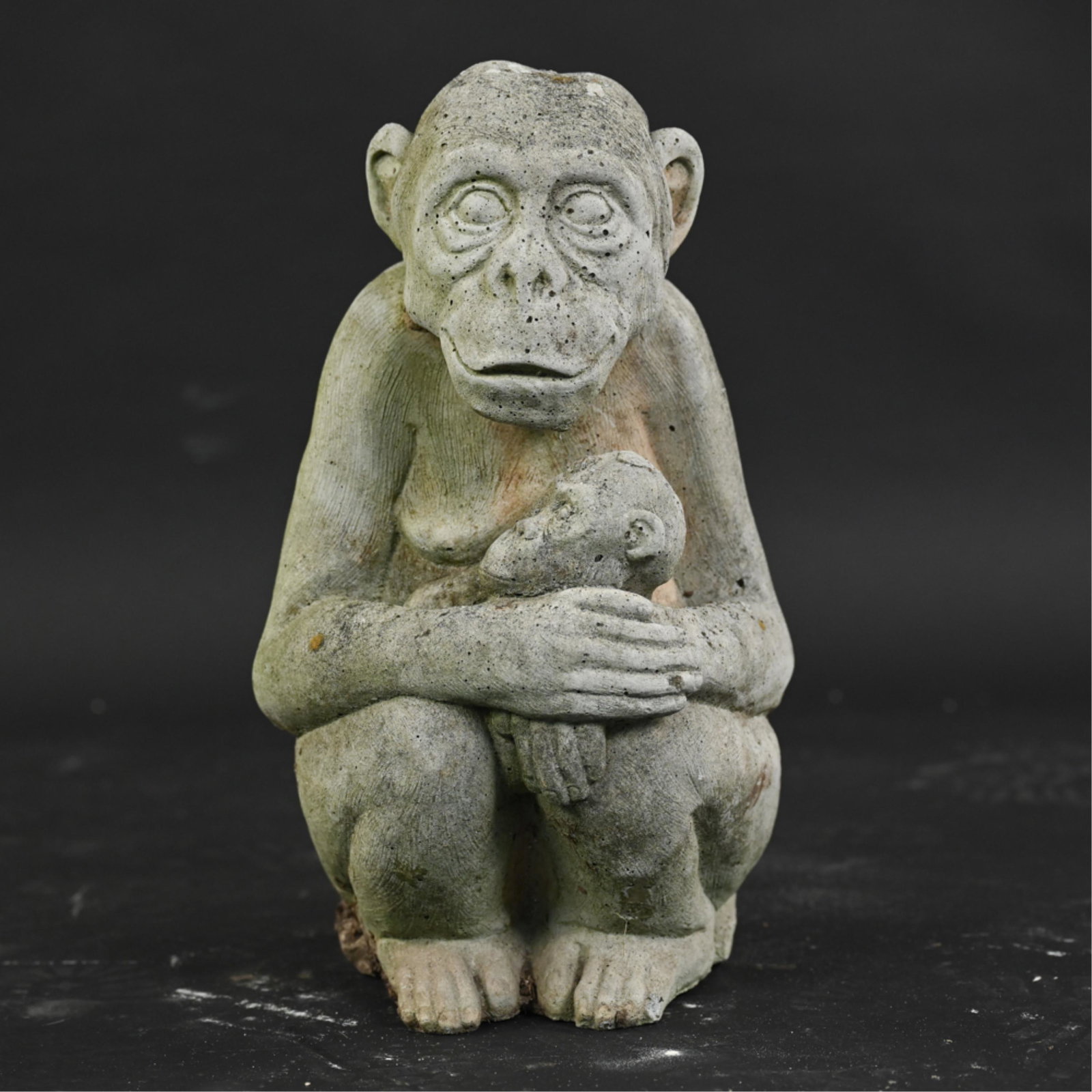 CONTEMPORARY CEMENT MONKEY GARDEN SCULPTURE: Mother monkey with baby. Dimensions: H 15.5" x W 9" x D 9.5" Condition: Surface weathering consistent with outdoor exposure.