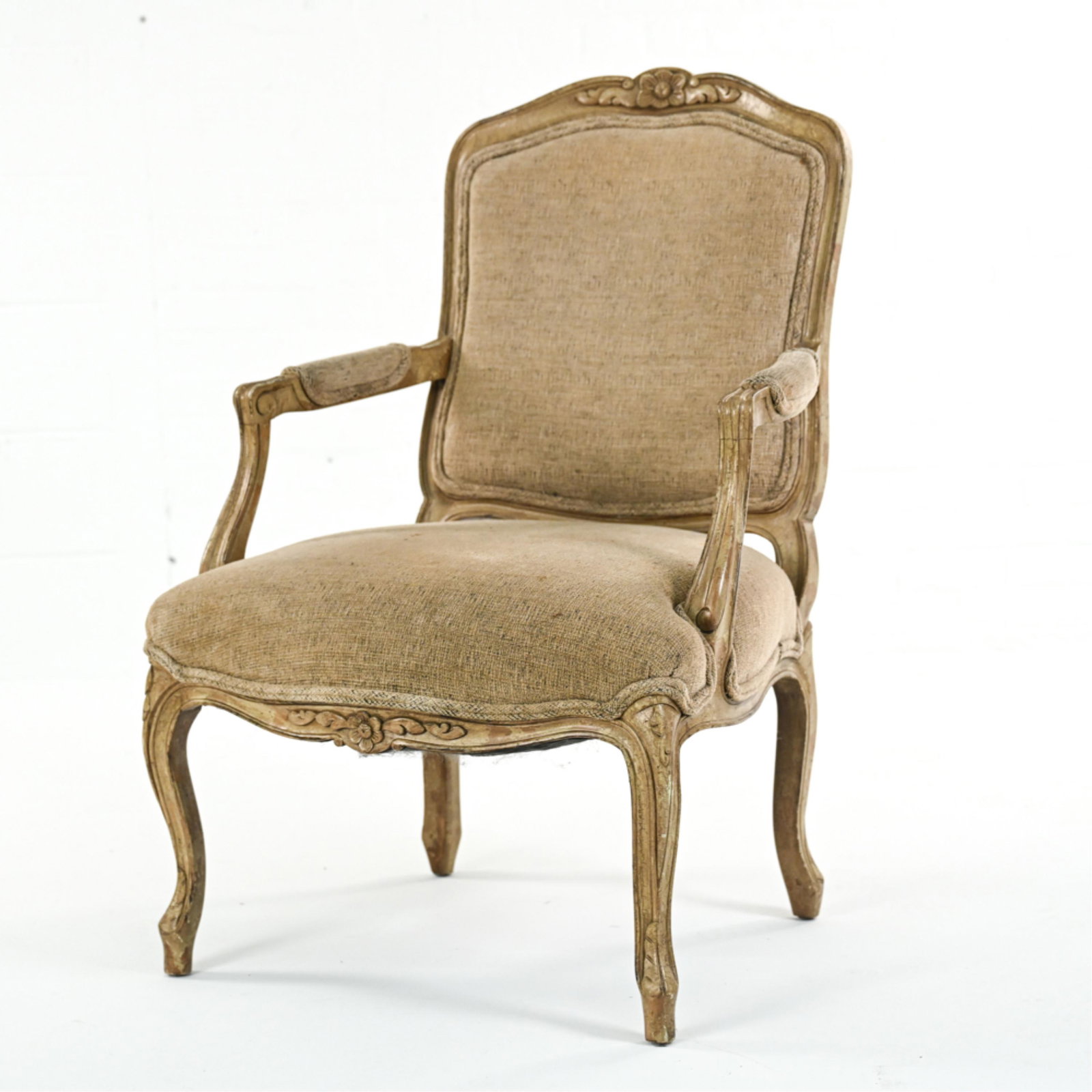 FRENCH LOUIS XV-STYLE FAUTEUIL ARMCHAIR: Carved wood frame with cabriole legs. Dimensions: H 37.5" x W 25.5" x D 20.5" x SH 17.5" Condition: Some soiling to upholstery. Few nicks and wear to frame.