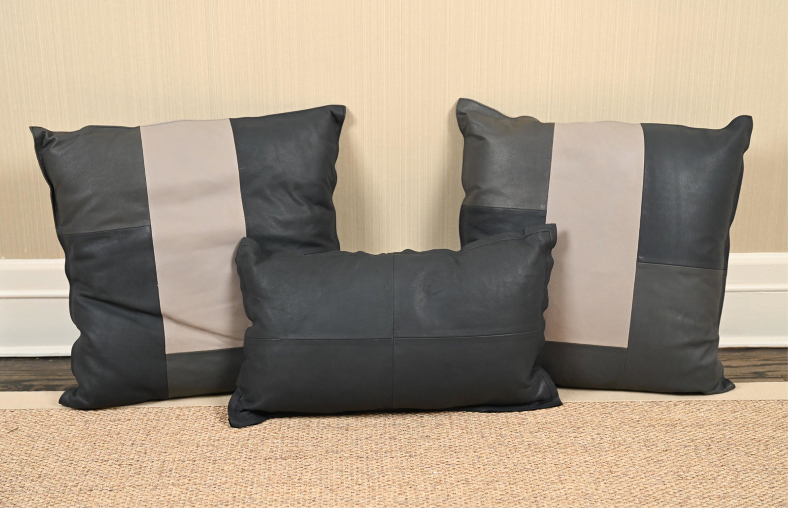 (3) FIBRE BY AUSKIN LEATHER THROW PILLOWS: Soft full grain leather fronts with napped suede backs and down inserts. Dimensions: (Larger pillows) L 19" x W 19" (Small pillow) L 20" x W 11.75" Condition: Unused, with original retail tags; showin